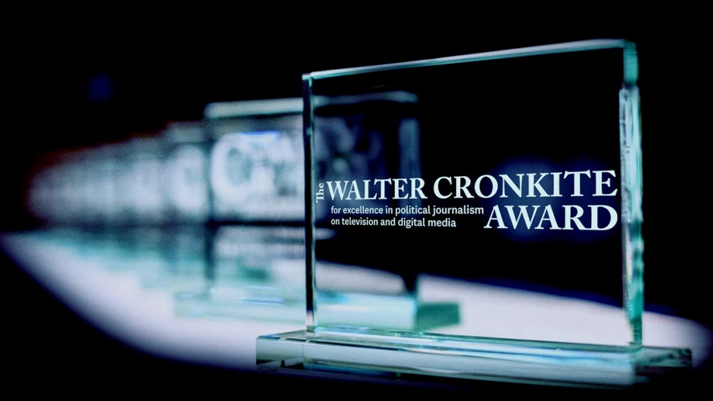 Glass awards extend back into a black background.